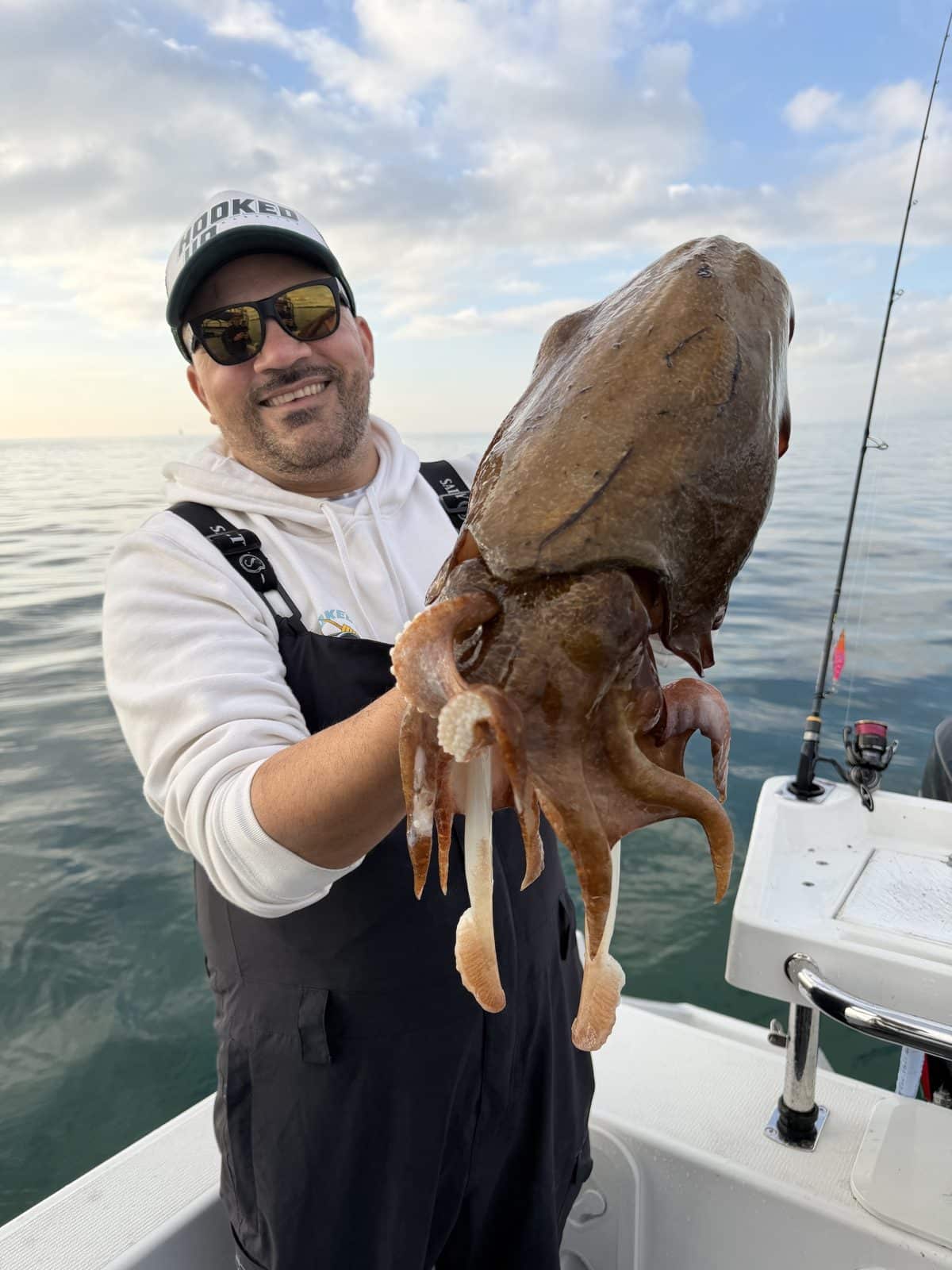 Angler holding a large southern calamari caught on a Yamashita EGI-OH Search Shallow squid jig