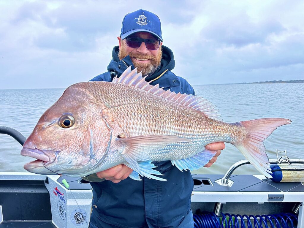 Angler with a Westernport snapper on a calm day